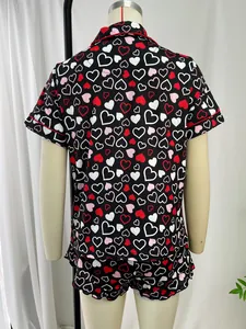 Back view of women's short sleeve pajama set featuring vibrant red and white heart patterns