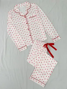 Soft white women's two-piece pajama set with red heart print and elegant lapel design