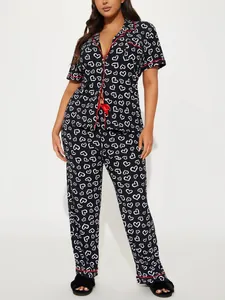 Two-piece black pajama set for women featuring white heart print and red piping