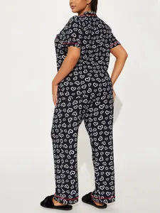 Back view of women's two-piece heart print pajama set with short sleeves and pants.