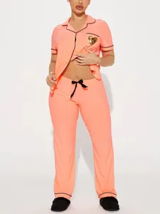 Detail of peach women's pajama set with short sleeve top and long pants homewear