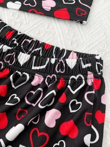 Close-up view of heart print pattern on elastic waistband of black women's pajama.