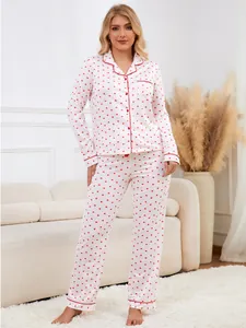 Full length view of white long-sleeve pajama set with red heart pattern on model