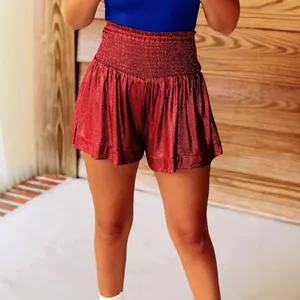Glamorous shimmering red metallic high-waisted shorts with comfortable smocked waistband