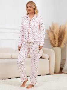 Full body view of women's white pajama set with red heart print and piping detail.