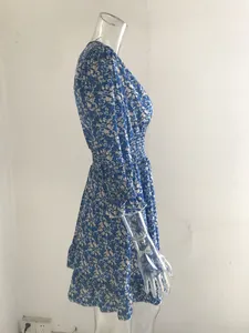 Detailed view of a blue bohemian floral dress with smocked waist and ruffled sleeves