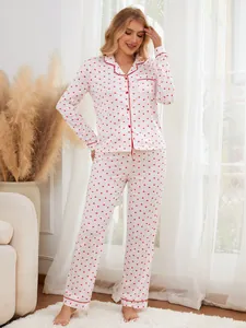 Full view of women's heart print pajama set with red piping details