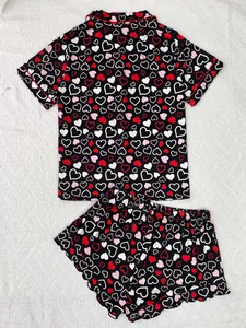 Women's heart print two-piece pajama set with short sleeves and ruffled hem shorts