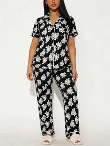 Front view of black and white floral print pajama set with short sleeves and pants