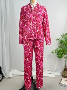 Detailed view of women's long-sleeve pajama set featuring vibrant pink psychedelic print.