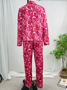 Rear view of women's long-sleeve pajama set with pink retro psychedelic floral print