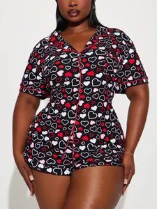 Front view of women's short-sleeve heart print pajama set with red piping detail