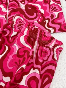 Detailed macro view of pink psychedelic print pajama pants with elastic waistband