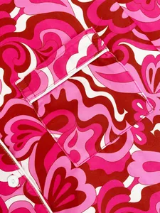 Macro detail showing the pink and red floral print pocket of a cozy women's pajama set