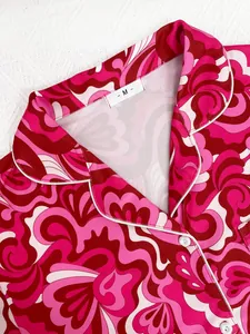 Close-up of pink floral print pajama top showing notched collar and white button details