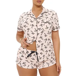 Two-piece pink pajama set for women with bow prints and short sleeves