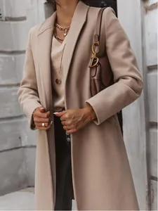 Close-up detail of women's beige mid-length woolen coat with elegant lapel design