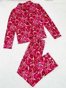 Detail view of women's pink abstract print pajama set with piped notched collar and pants