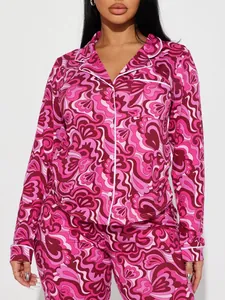 Close-up detail of women's vibrant pink swirl print pajama set with button-down lapel