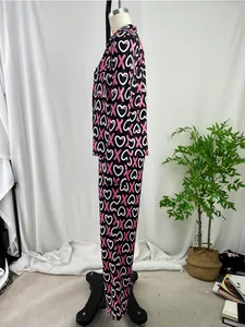 Side profile view of women's long sleeve pajama set with pink X and white heart print