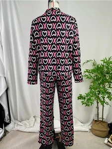 Detailed back view of a black long-sleeved pajama set featuring pink X and heart pattern