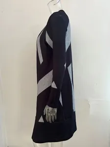 Detailed side view of a black long-sleeved knitted cardigan with grey geometric prints