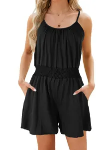 Detail view of a black spaghetti strap romper with an elastic waist and side pockets.