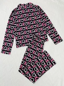 Detailed look at the pink heart and X letter print on black women's pajama set