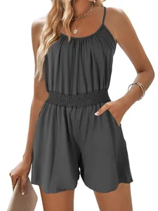 Close-up detail of a charcoal grey sleeveless romper with smocked waist and side pockets
