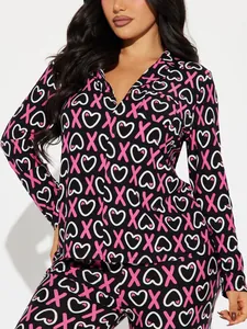 Detailed view of women's black pajama set with pink XOXO and heart pattern prints