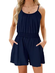 Navy blue sleeveless romper with smocked waist and side pockets worn by a model.