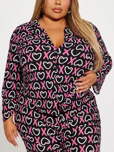Close-up of plus size women's two-piece pajama set with pink XOXO and heart print