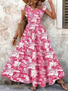 Detail of pink vintage tropical print maxi dress with V-neck and tiered skirt.