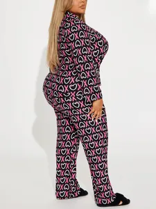 Side view of women's black pajama set with pink X and white heart prints