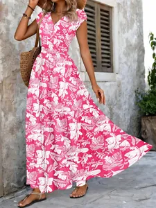 Detail of vintage floral print on a vibrant rose red V-neck maxi dress for summer fashion.
