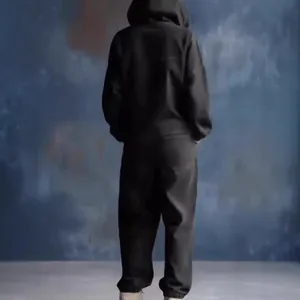 Rear view showing the fit and hood of a black casual denim hooded jumpsuit with pockets.