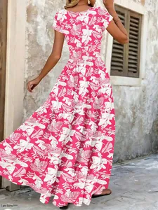 Detailed back view of a vibrant pink vintage floral maxi dress with white tropical leaf prints.