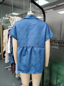 Back view of a casual blue imitation denim short sleeve shirt displayed on a shop mannequin