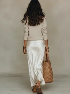 Vue arrière d'un ensemble 2 pièces élégant avec pull en maille crème et jupe en satin