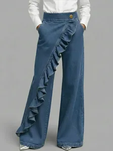 Detail of retro high-waisted wide-leg jeans featuring an irregular diagonal ruffle design.