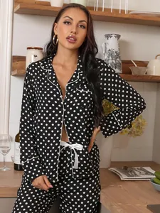 Elegant black and white polka dot long sleeve pajama set for women in cozy kitchen
