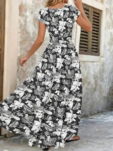 Elegant black and white leaf print maxi dress with tiered skirt design