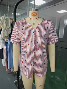 Close-up of red and white striped short-sleeved shirt with colorful heart prints