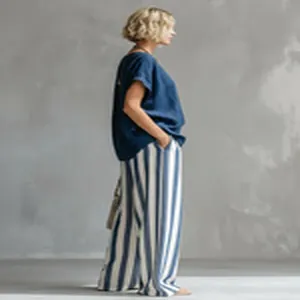 Mujer con top azul marino y pantalones anchos a rayas azules y blancas conjunto