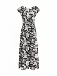 Macro view of the black and white tropical leaf pattern on this elegant V-neck maxi dress