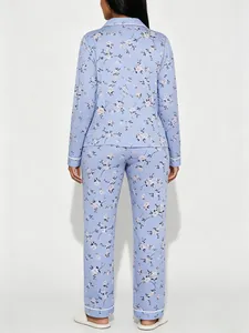 Back view of women's floral print pajama set with long sleeves and elegant piping details