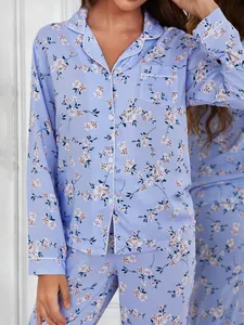 Close-up detail of a light blue floral pajama set with white piping and lapel collar.