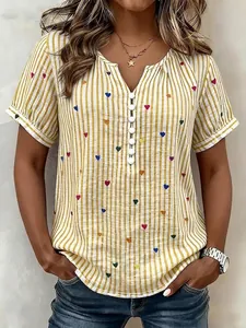 Detailed view of women's short sleeve blouse with yellow stripes and heart print pattern.