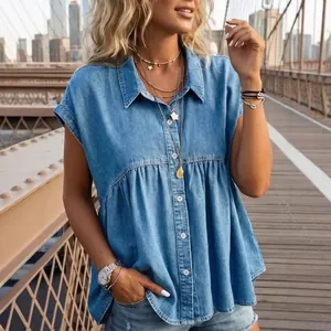 Stylish women's light blue chambray babydoll sleeveless button-up shirt in urban setting