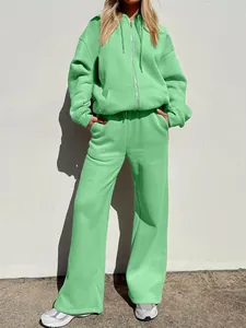 Full body view of a mint green oversized hoodie and wide-leg tracksuit set for women.